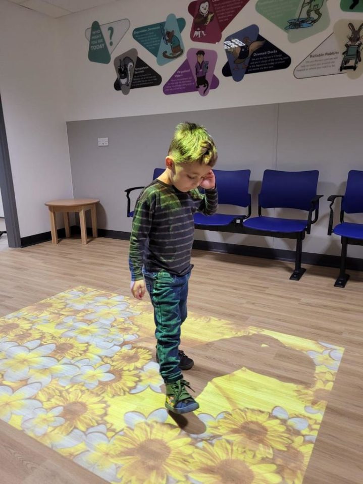 Young patient trying out the interactive floor projector at Leighton