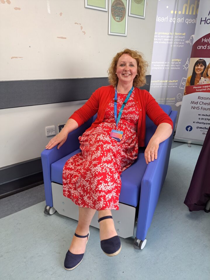 Palliative Care nurse Mary Buttle tries out the sleeper chair 