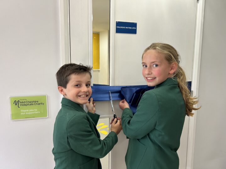 children cutting the ribbon to officially open the room