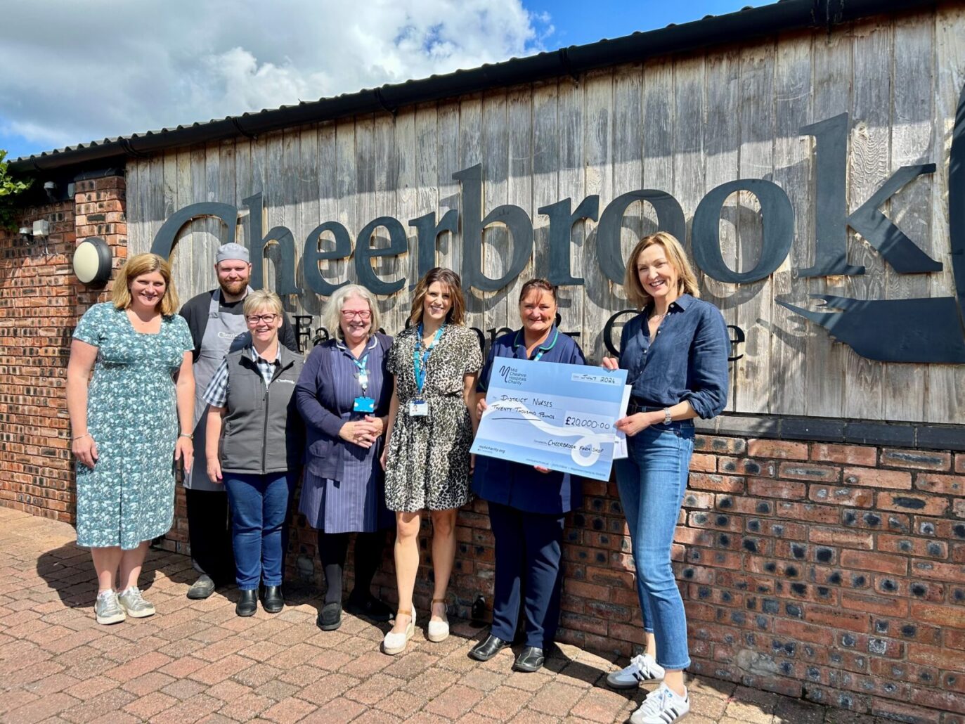 Sarah Shufflebotham, director of Cheerbrook (R) hands over a cheque for £20k to the District Nursing Team