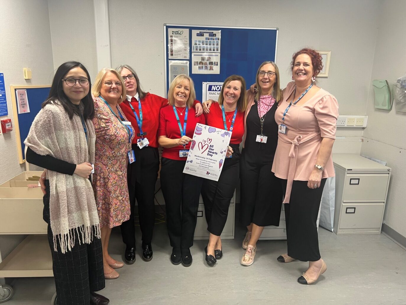 Group of people wearing pink or red to show their support for the charity's end of life care appeal on All Our Hearts Day