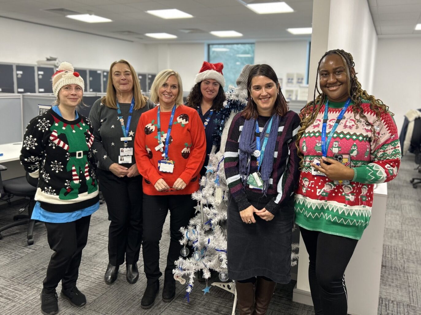 Group of people wearing festive jumpers