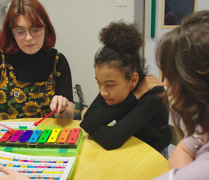 Little girl plays musical instrument