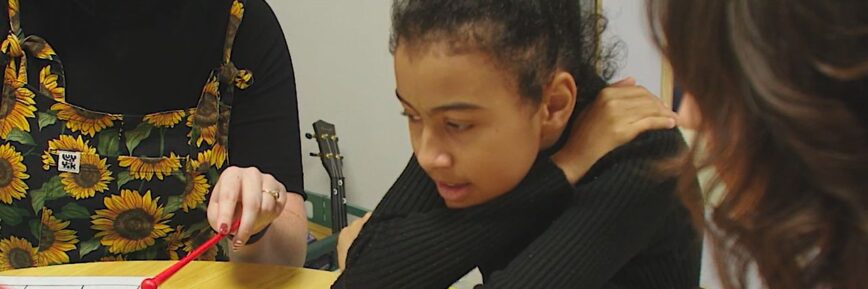 Little girl plays musical instrument