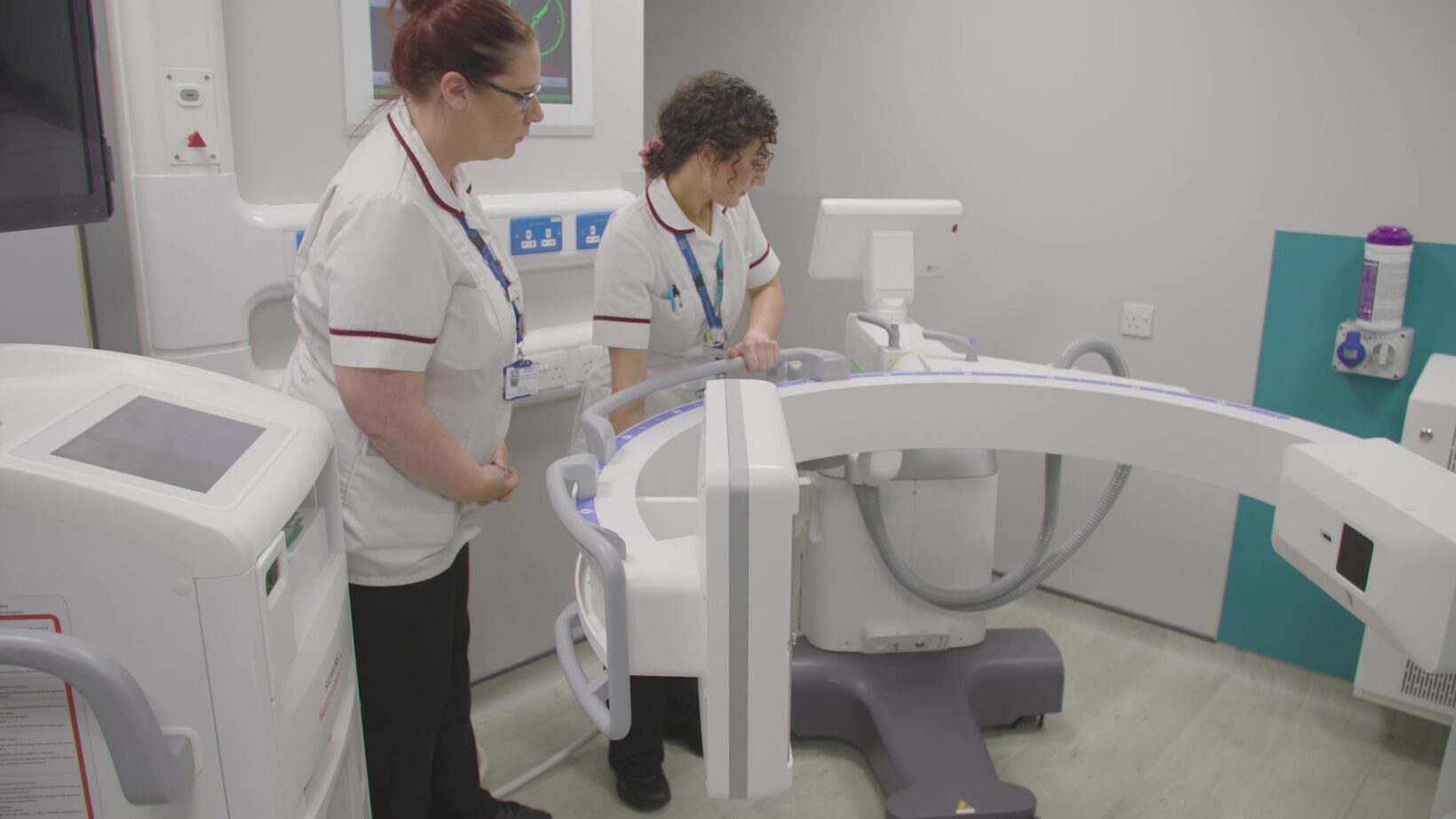 Photo of clinical staff with large C-Arm X-Ray machine